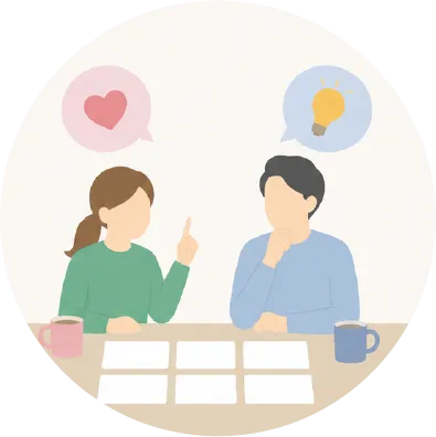 テーブルにカードを広げ、夫婦が向かい合って話し合っているイラスト